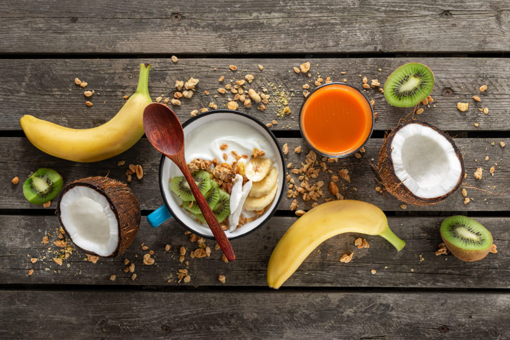 Benefícios dos probióticos: frutas, amêndoas, castanhas e nozes espalhados sobre a mesa.